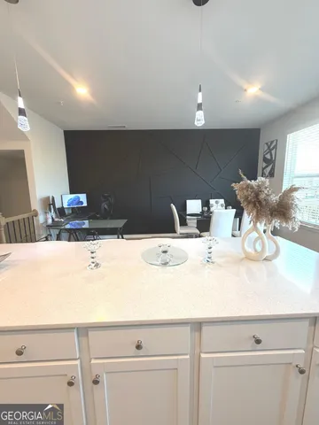 a kitchen with a sink and white cabinets