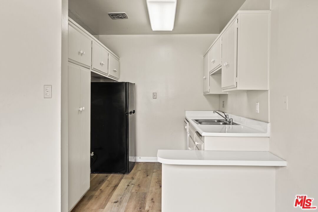 1295 Federal Avenue, Unit 3 Los Angeles, CA 90025 - Photo 2 of 12 a kitchen with stainless steel appliances a sink stove and refrigerator