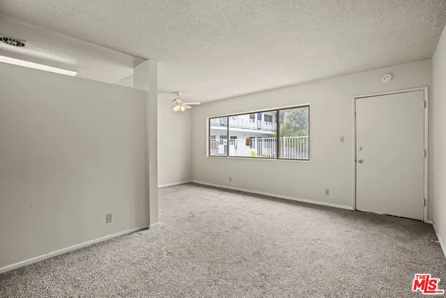 a view of an empty room with windows