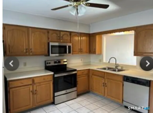a kitchen with a sink stove and microwave