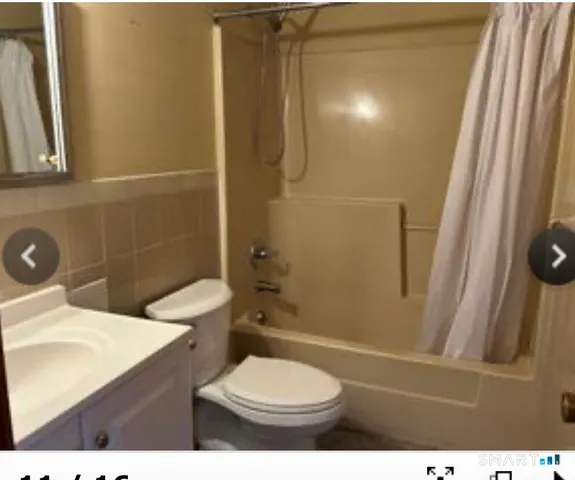 a bathroom with a toilet a sink and shower