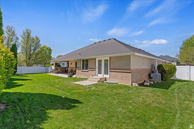 1924 North 2000th Street East Layton, UT 84040 - Photo 38 of 41 Rear view of property with a fenced backyard, brick siding, a patio, and french doors
