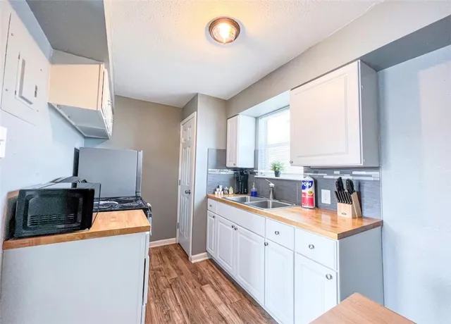 a kitchen with a sink stove and cabinets