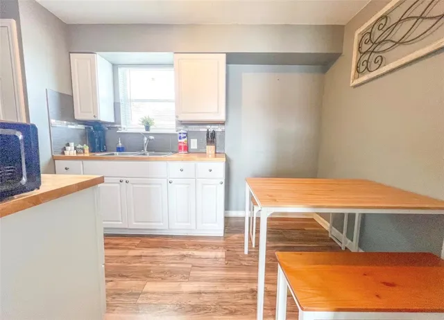a kitchen with a sink a stove and cabinets