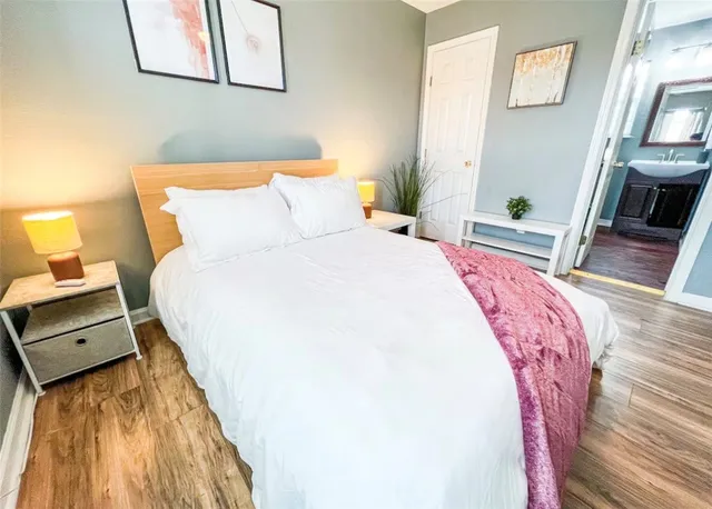 a bedroom with a bed and a flat screen tv