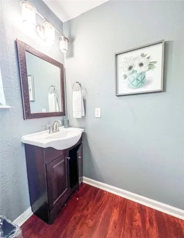 a bathroom with a sink vanity and a mirror