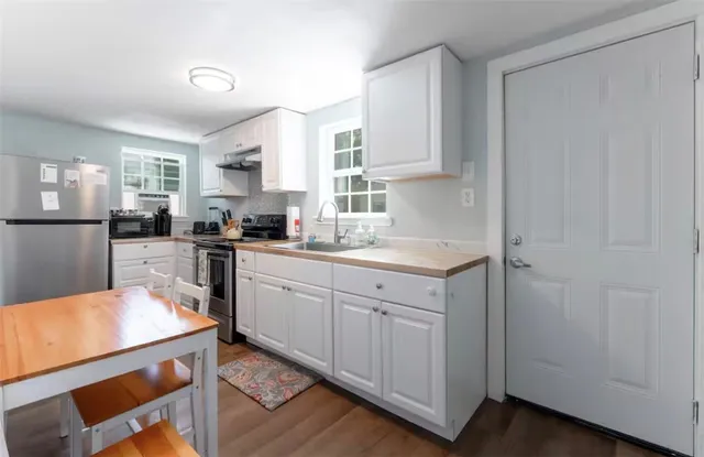 a kitchen with a sink stove and cabinets