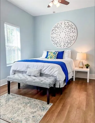 a bed sitting in a bedroom next to a window with a dresser