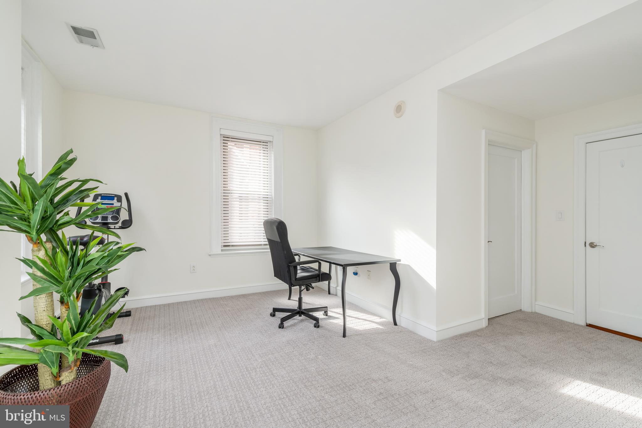1811 Chestnut Street, Unit 707 Philadelphia, PA 19103 - Photo 17 of 39 a view of a workspace with furniture and a potted plant