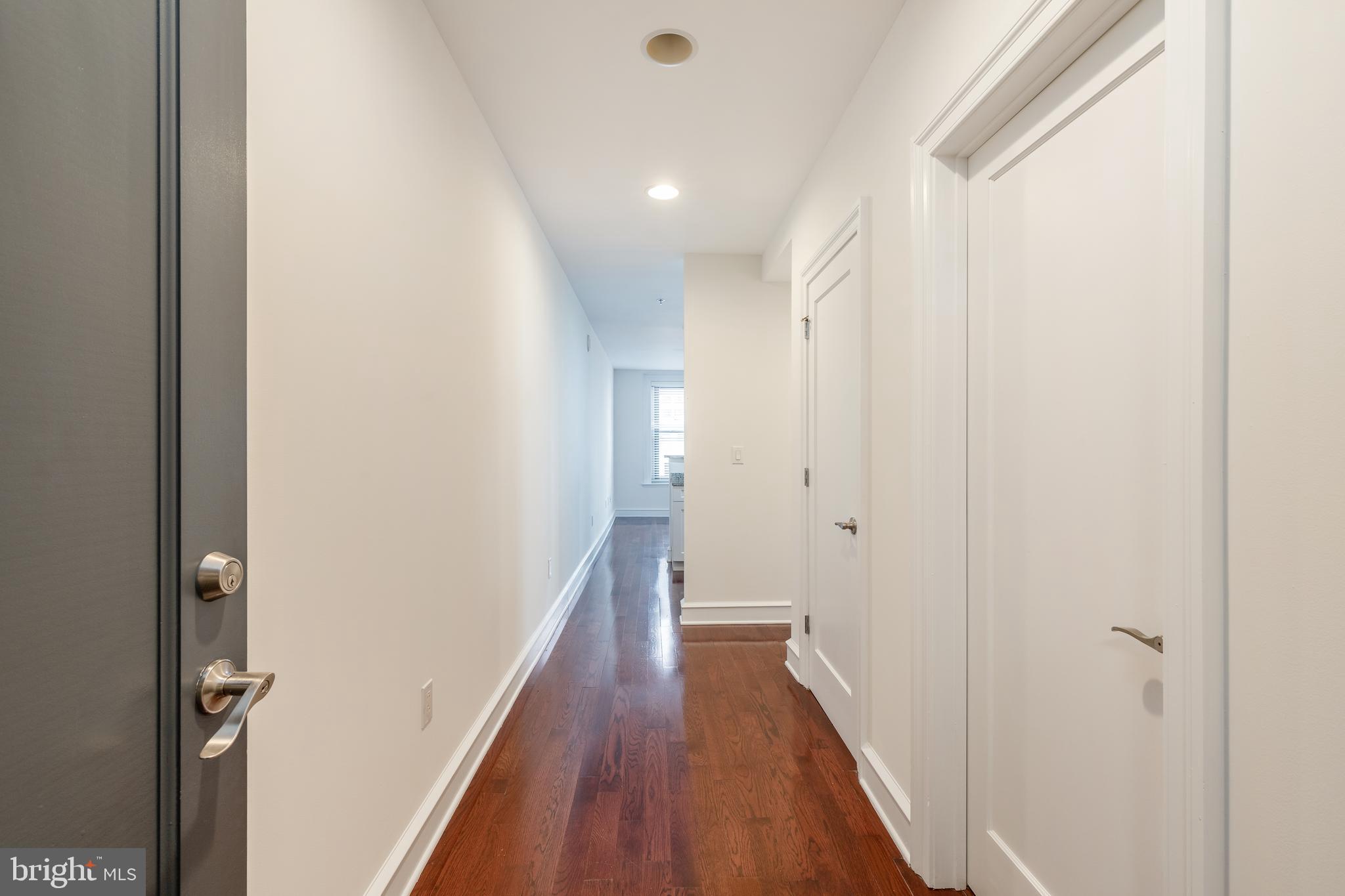 1811 Chestnut Street, Unit 707 Philadelphia, PA 19103 - Photo 2 of 39 a view of a hallway with wooden floor