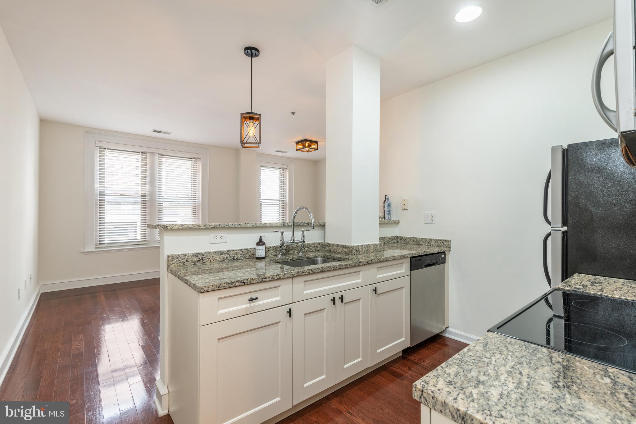 1811 Chestnut Street, Unit 707 Philadelphia, PA 19103 - Photo 5 of 39 a kitchen with a sink appliances and a window