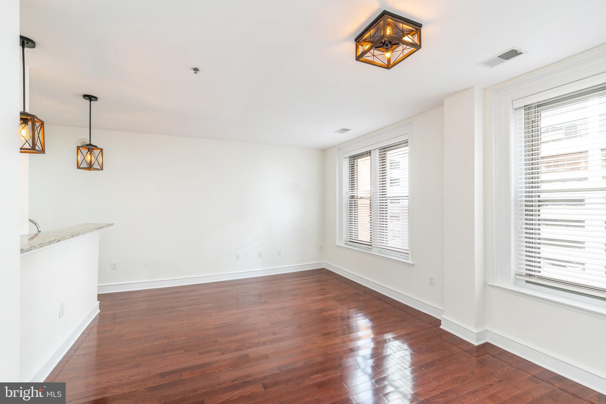1811 Chestnut Street, Unit 707 Philadelphia, PA 19103 - Photo 8 of 39 a view of a livingroom with wooden floor and window
