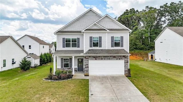 a front view of a house with garden