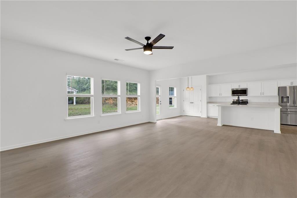 111 Weston Way Northwest Cartersville, GA 30121 - Photo 11 of 41 a view of a livingroom with a ceiling fan & windows