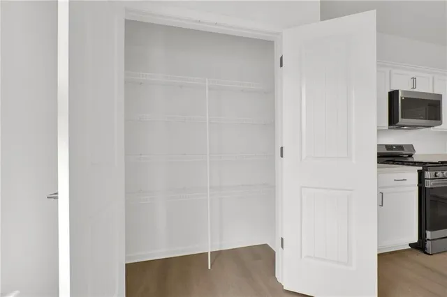 a view of a kitchen with an empty space and a window