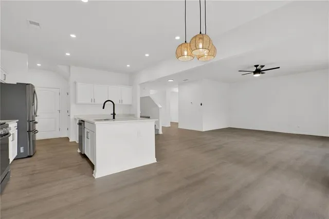 a view of a kitchen with a sink and chandelier