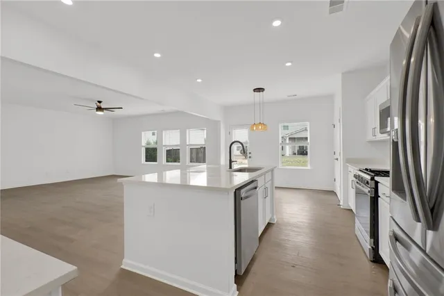 a kitchen with stainless steel appliances a refrigerator and a stove