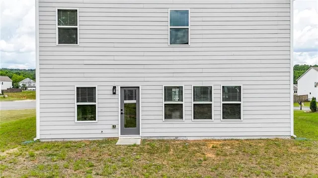 a view of a house with a backyard