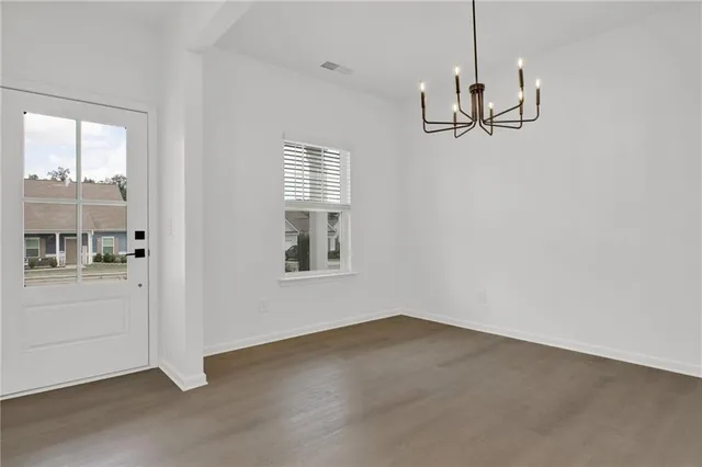 a view of empty room with windows and ceiling fan
