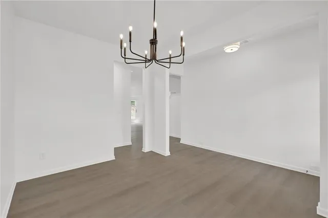 a view of a room with wooden floor and a ceiling fan