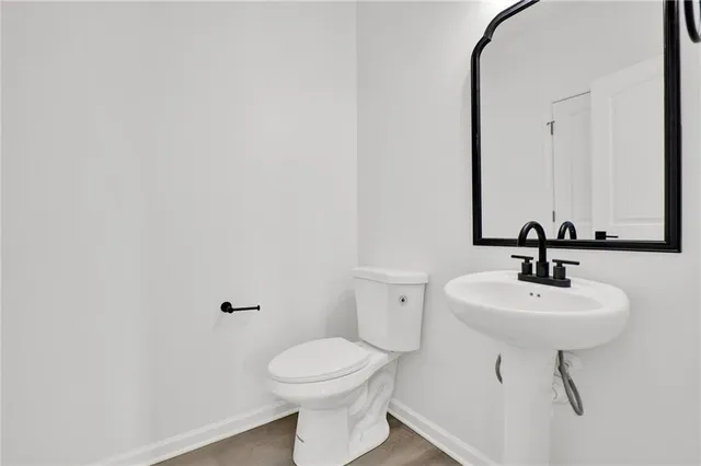 a bathroom with a sink toilet and mirror