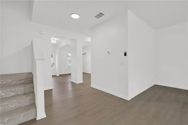 a view of a hallway with wooden floor