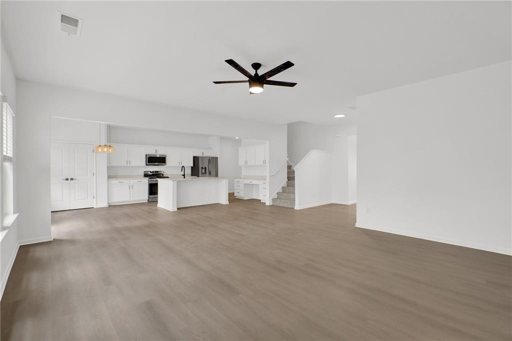 111 Weston Way Northwest Cartersville, GA 30121 - Photo 10 of 41 a view of a livingroom with a kitchen island with wooden floor