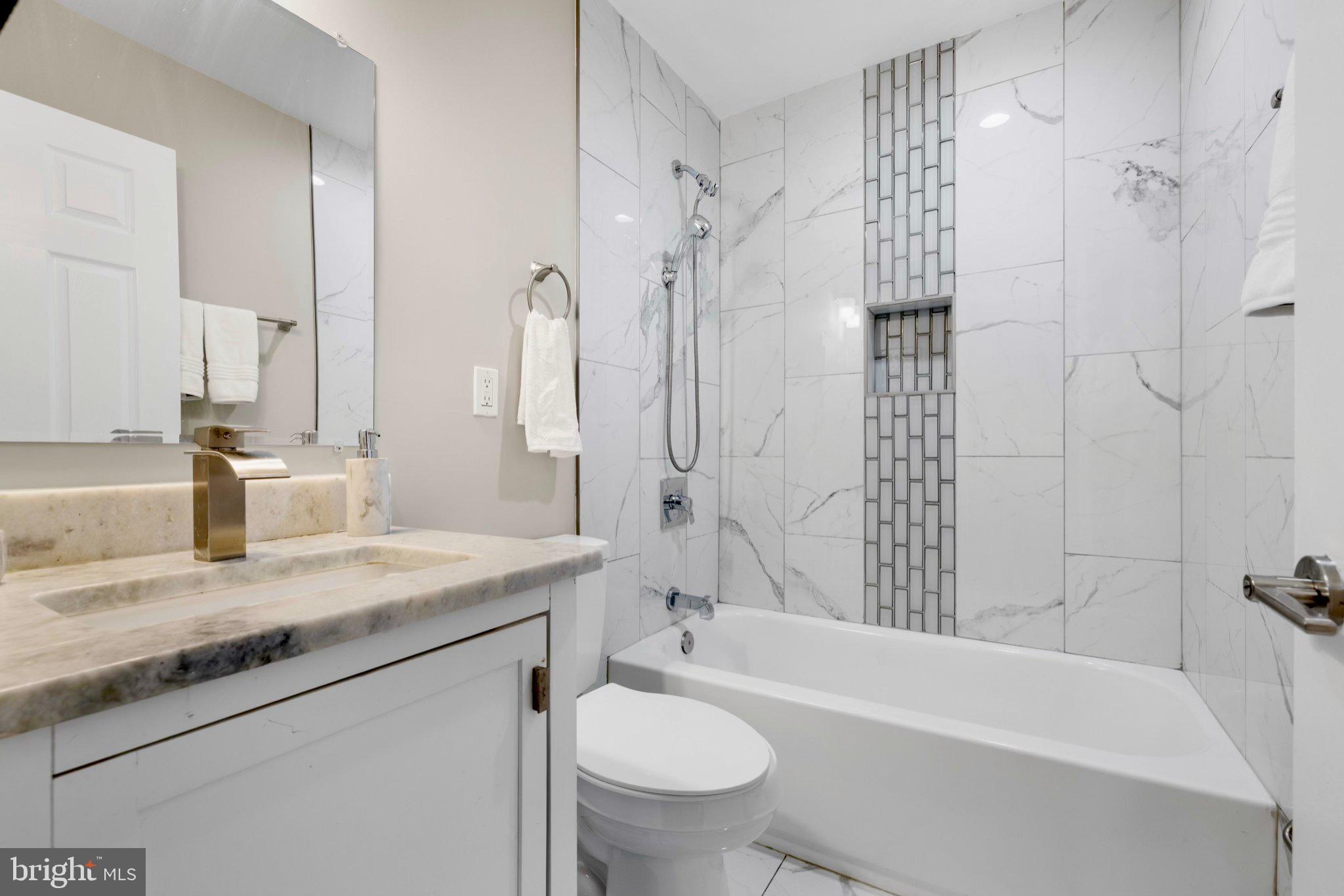 145 North Monastery Avenue Baltimore, MD 21229 - Photo 13 of 45 Sleek modern bathroom with elegant tiles.
