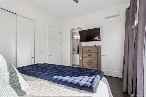 a bedroom with a bed a dresser and a window