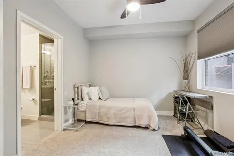 a bedroom with a bed and a flat tv screen