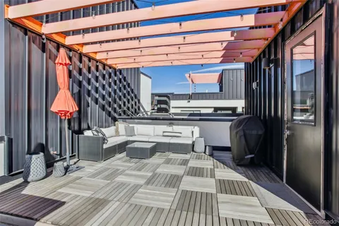 a view of roof deck with wooden floor and seating space