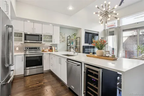 a kitchen with kitchen island granite countertop a stove cabinets and a refrigerator