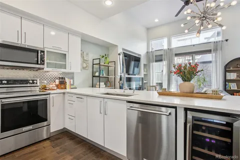 a kitchen with stainless steel appliances granite countertop a stove and a sink