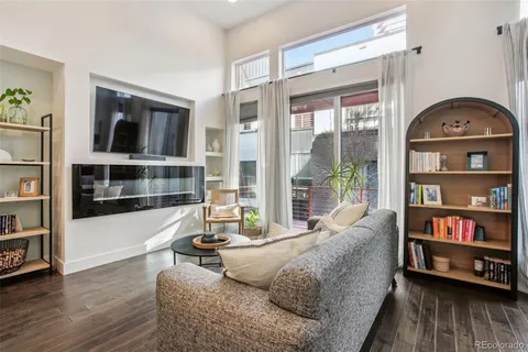 a living room with furniture and a book shelf