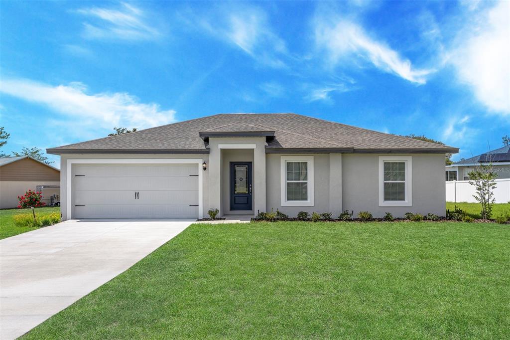 14758 Southwest 27 Ct Road Ocala, FL 34473 - Photo 1 of 1 a front view of a house with a yard
