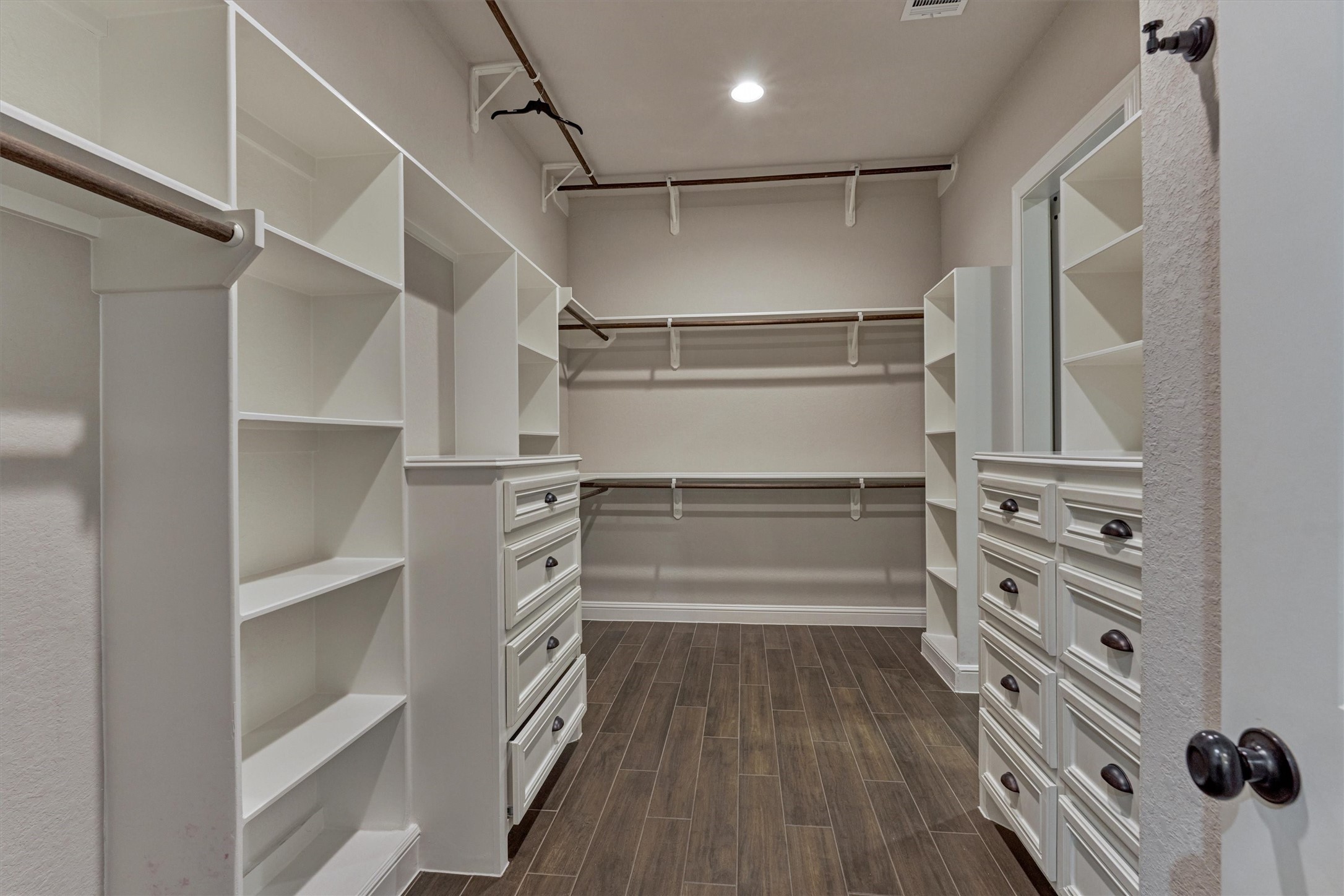 11618 Renaissance Drive Montgomery, TX 77356 - Photo 21 of 49 Welcome to your dream closet, featuring built-in drawers, custom shelving, and tiered hanging space for optimal organization. As an added bonus, it offers direct access to the laundry room for everyday convenience.