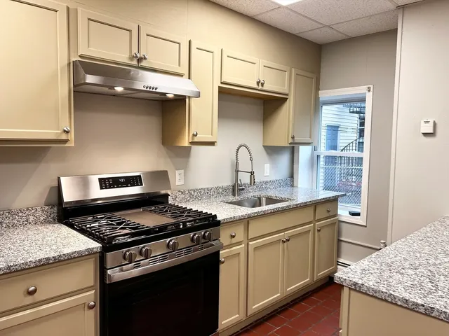 a kitchen with stainless steel appliances granite countertop a stove and a sink