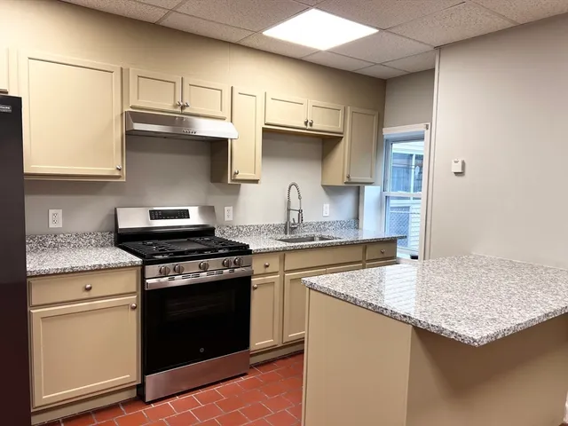 a kitchen with stainless steel appliances granite countertop a stove and a sink