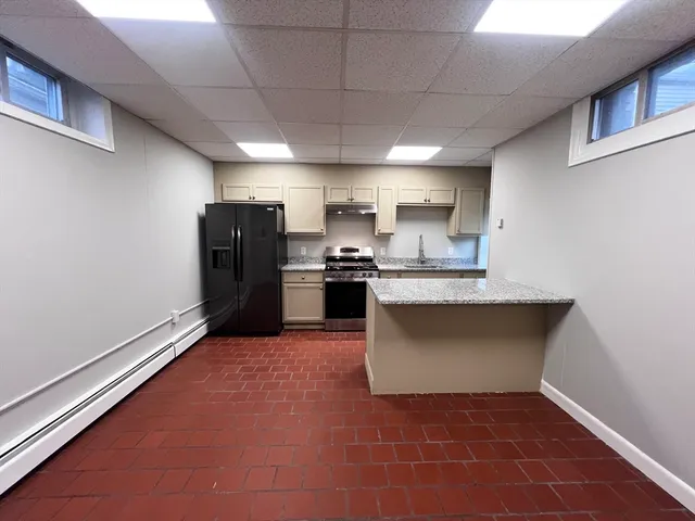 a kitchen with stainless steel appliances granite countertop a refrigerator and a sink