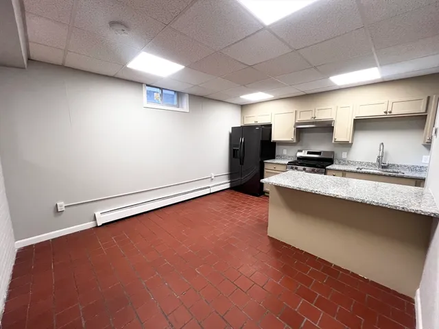a kitchen with stainless steel appliances a refrigerator and a stove top oven