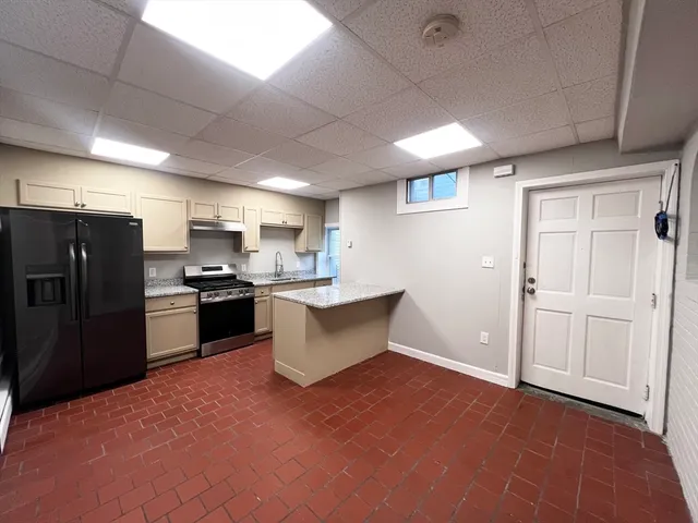 a kitchen with refrigerator and cabinets