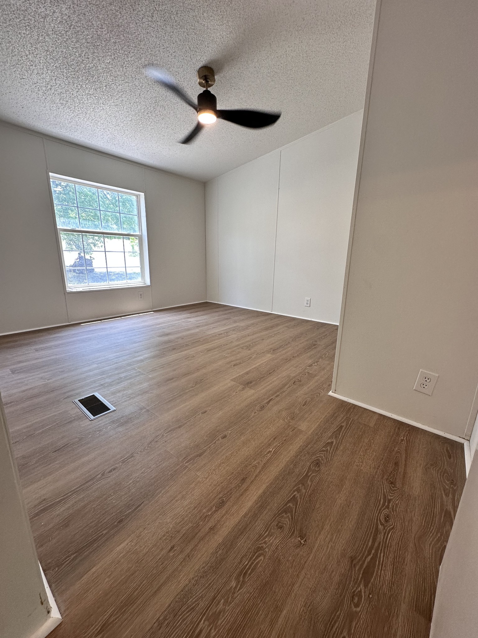 7287 Pinewood Road Nunnelly, TN 37137 - Photo 10 of 18 wooden floor in an empty room with a window