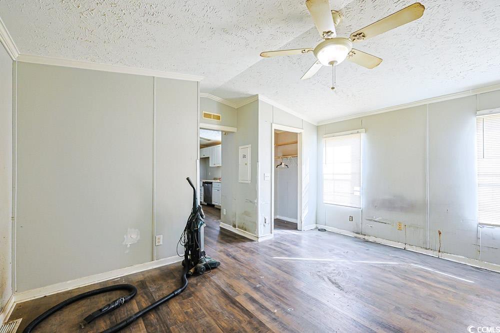 175 Darlene Drive Myrtle Beach, SC 29588 - Photo 12 of 31 Exercise area with crown molding, a textured ceiling, wood finished floors, a ceiling fan, and lofted ceiling