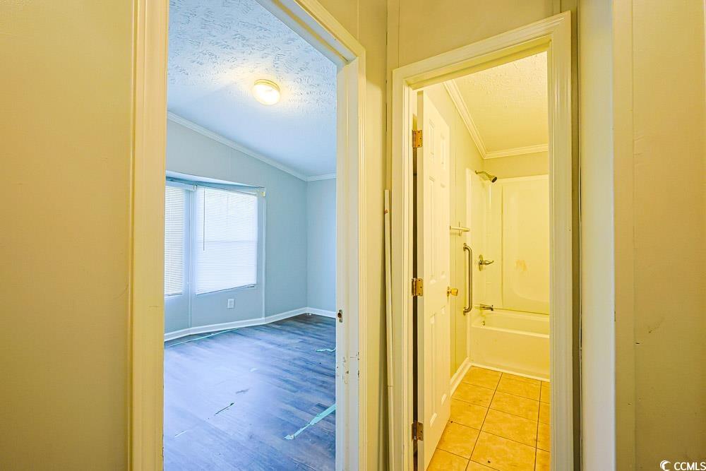 175 Darlene Drive Myrtle Beach, SC 29588 - Photo 21 of 31 Hallway featuring ornamental molding, a textured ceiling, light wood finished floors, and lofted ceiling
