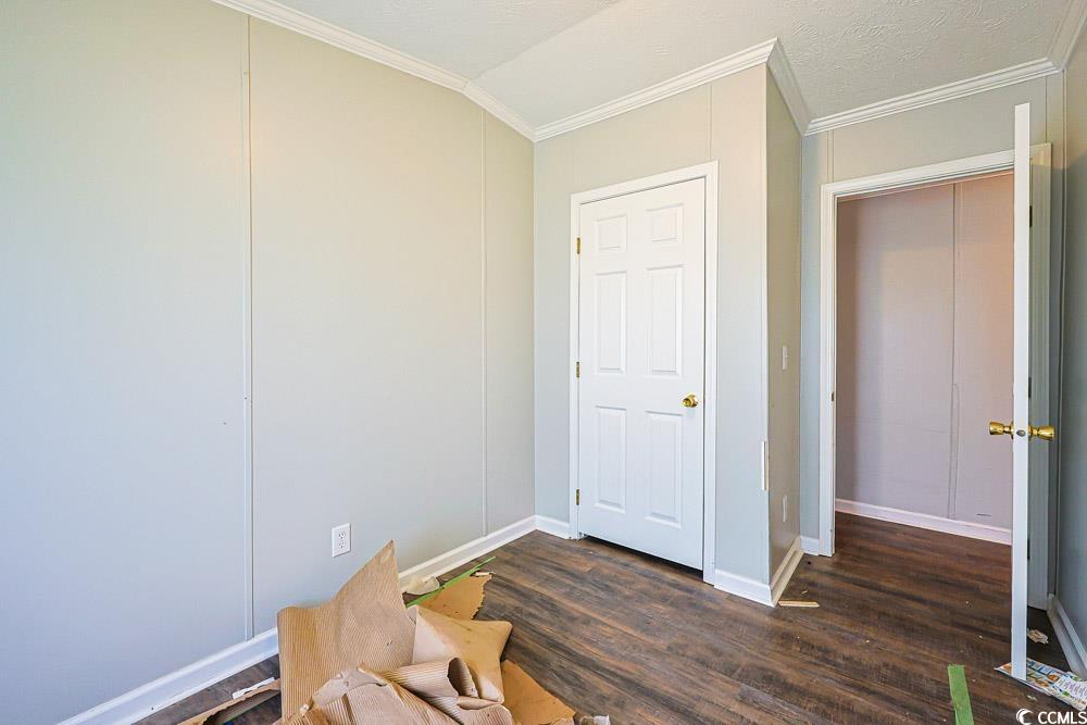 175 Darlene Drive Myrtle Beach, SC 29588 - Photo 23 of 31 Unfurnished room with ornamental molding and dark wood finished floors