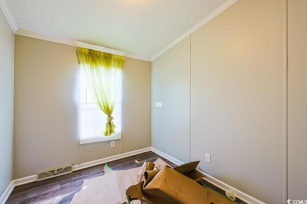 175 Darlene Drive Myrtle Beach, SC 29588 - Photo 24 of 31 Empty room with crown molding and wood finished floors