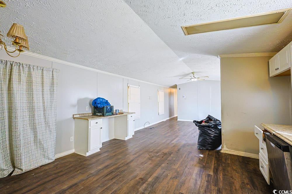 175 Darlene Drive Myrtle Beach, SC 29588 - Photo 8 of 31 Living room featuring dark wood-type flooring, a textured ceiling, lofted ceiling, and crown molding