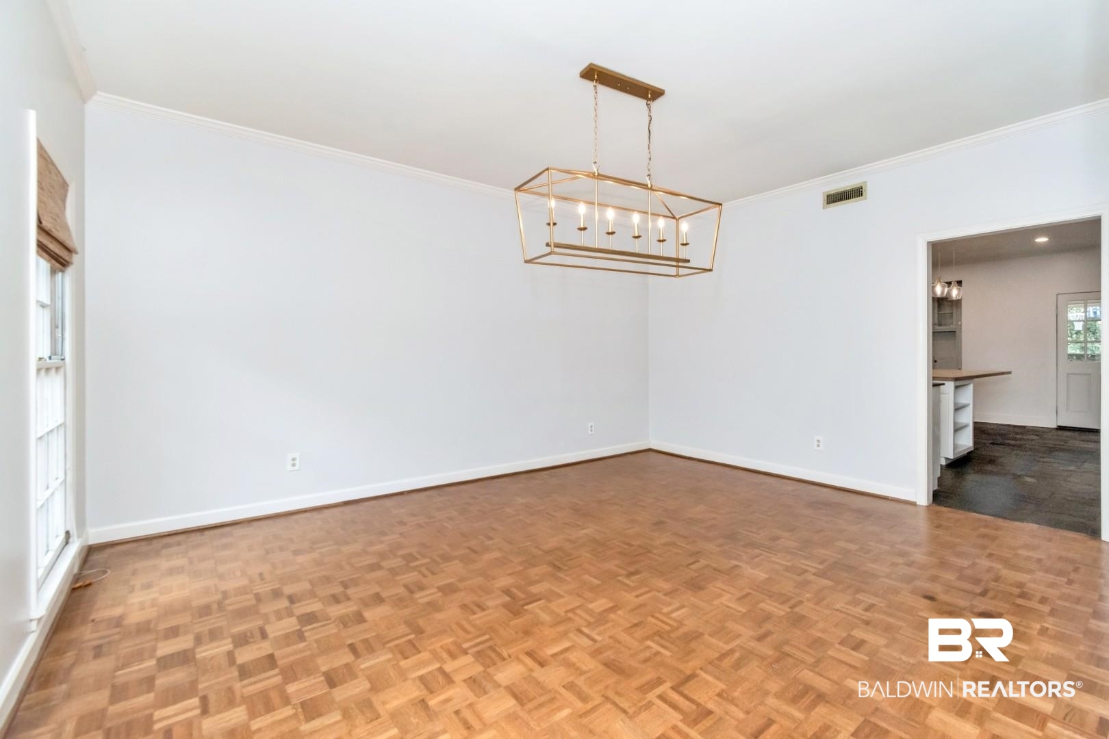4776 Falls Church Road Mobile, AL 36608 - Photo 7 of 45 Spacious room featuring parquet wood flooring, white walls, and crown molding