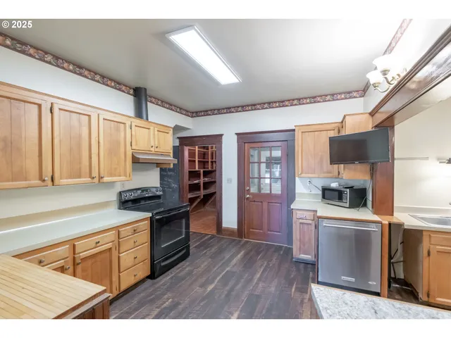 a kitchen with stainless steel appliances granite countertop a stove a sink dishwasher and a refrigerator