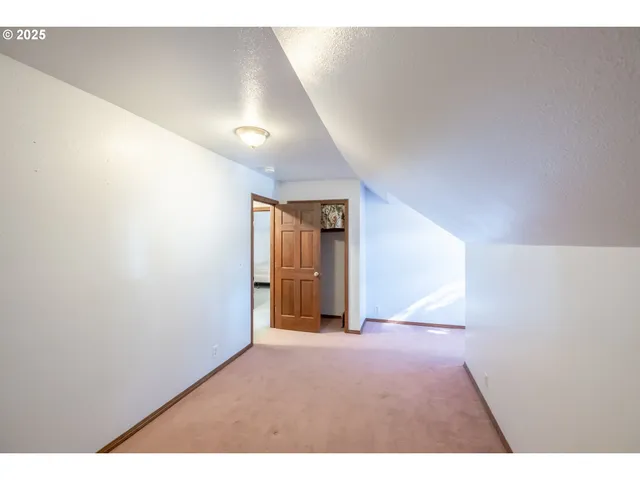 a hallway with a window and wooden floor